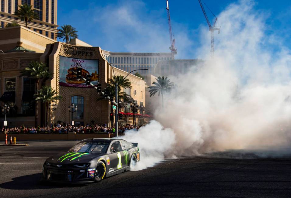 Kurt Busch performs a burnout during the NASCAR America Burnout Boulevard event on the Las Vega ...