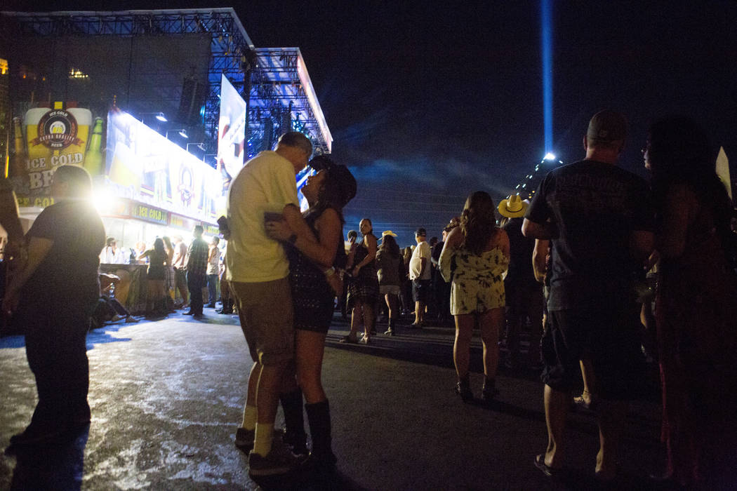 A couple slow dances while Chris Young performs during the second night of Route 91 Harvest cou ...