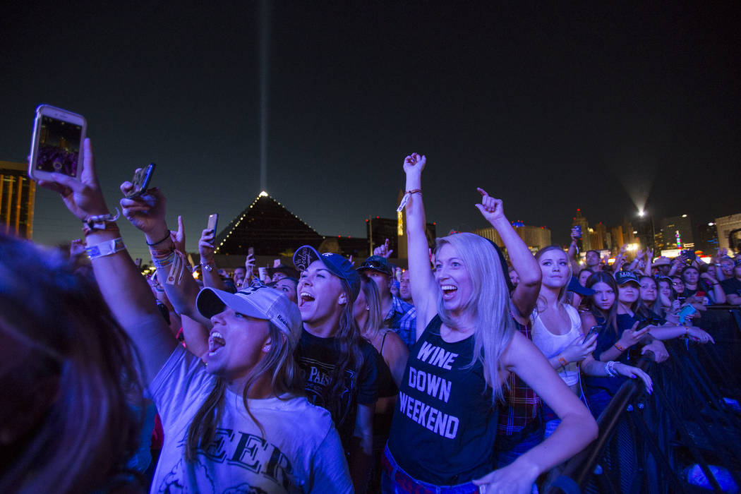 Festivalgoers enjoy the sounds of country music artist Dustin Lynch on Day 3 of the Route 91 Ha ...