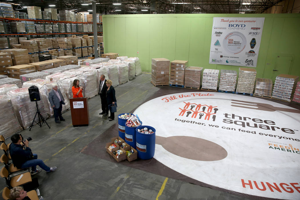 Three Square Food Bank Chief Development Officer Michelle Beck, second from left, thanks, from ...