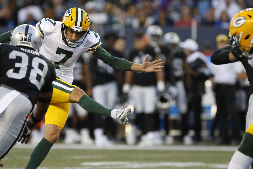 Green Bay Packers' Sam Ficken (7) kicks a field goal under pressure from Oakland Raiders' Keise ...