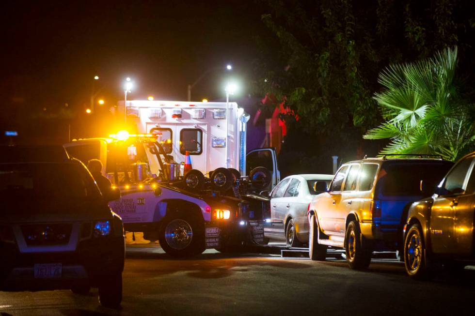 A tow truck prepares to move a vehicle blocking a driveway as Las Vegas police search a Spring ...