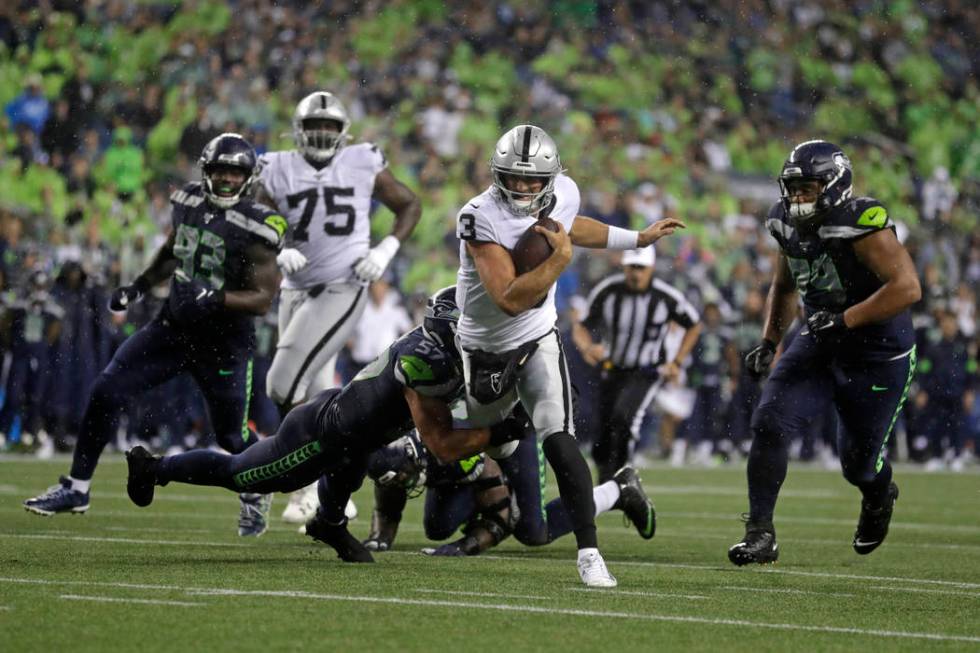 Oakland Raiders quarterback Nathan Peterman (3) scrambles, but Seattle Seahawks linebacker Cody ...