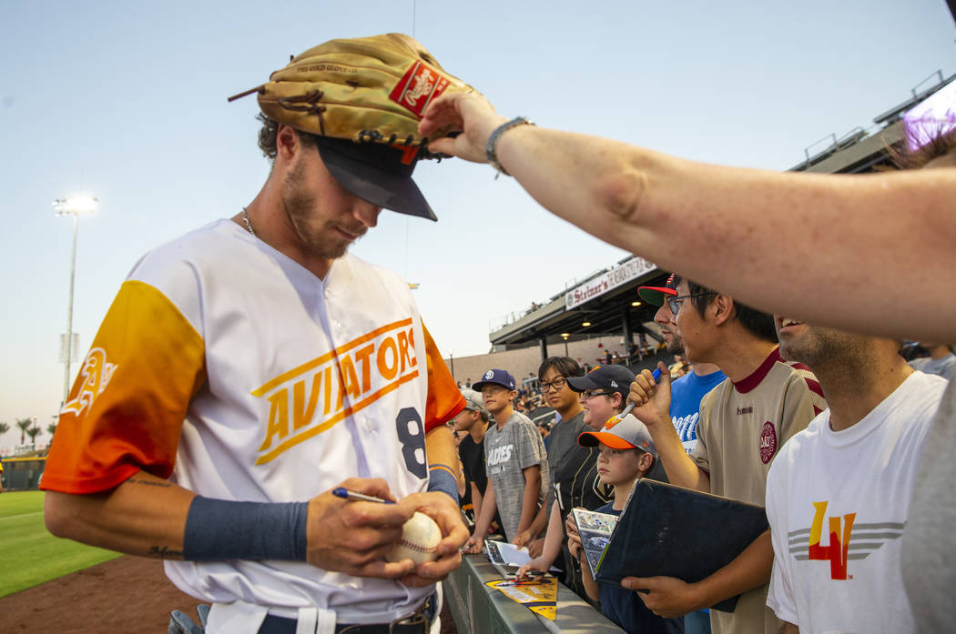 Las Vegas Aviators right fielder Skye Bolt (8) signs autographs with his glove on his head befo ...