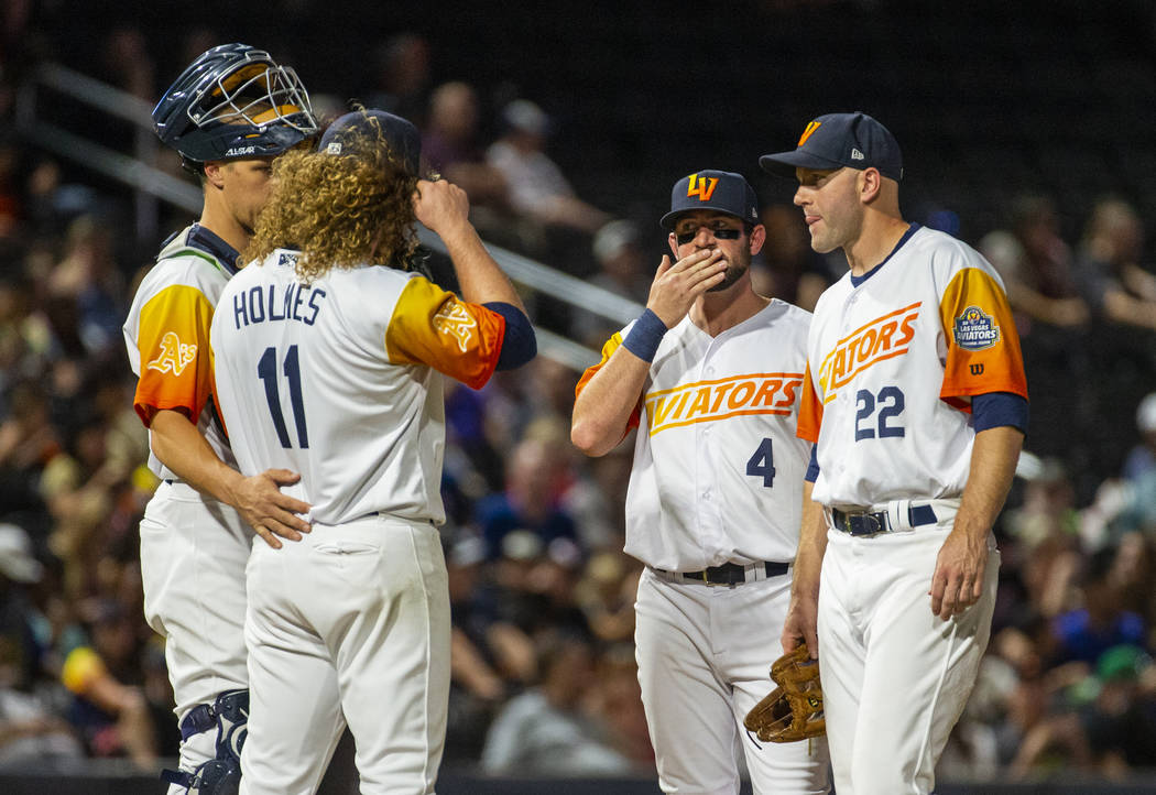 Las Vegas Aviators pitcher Grant Holmes (11) is consoled by teammates on the mound versus the S ...