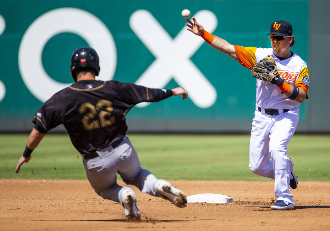 Las Vegas Aviators second baseman Trace Loehr (7, right) makes the out in the third inning on S ...