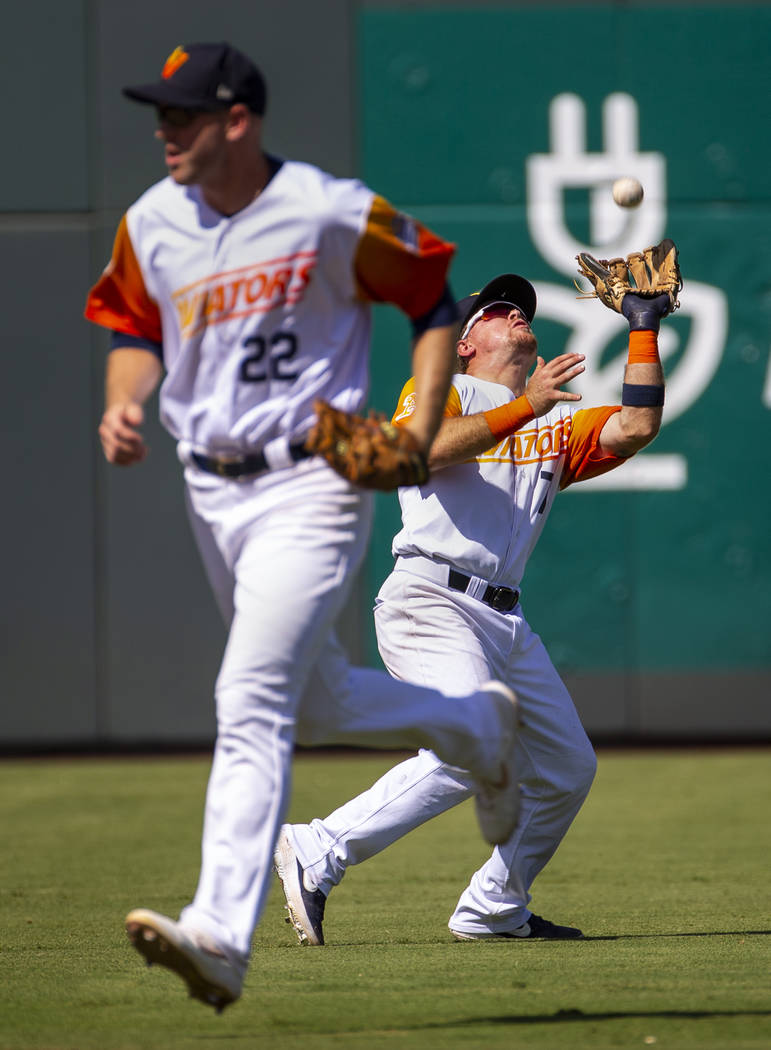 Las Vegas Aviators second baseman Trace Loehr (7, right) looks in a fly ball in the 8th inning ...