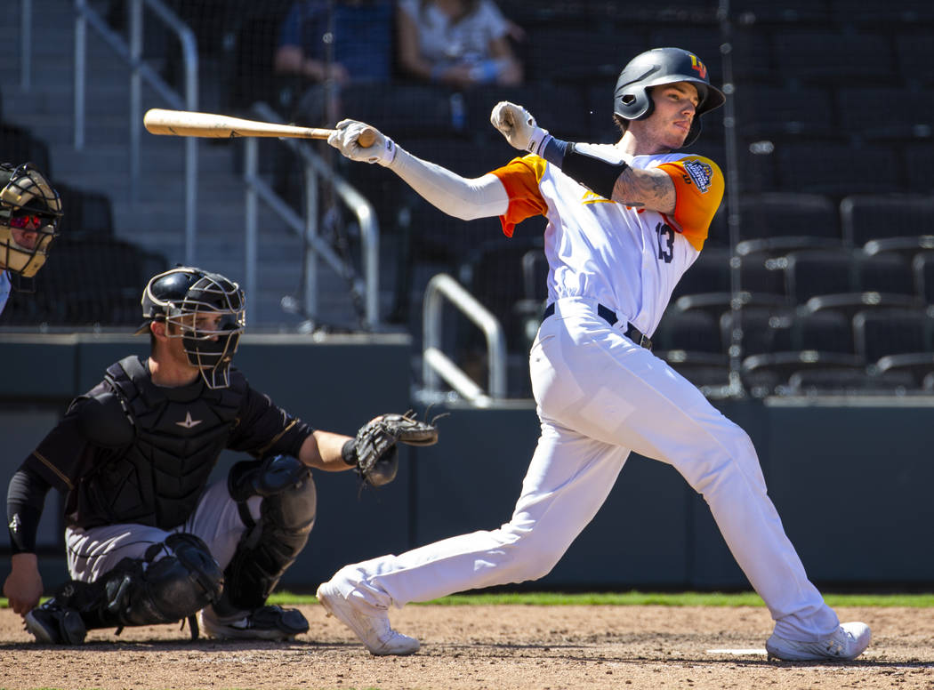 Las Vegas Aviators catcher Jonah Heim (13) misses the ball while batting in the ninth inning ve ...