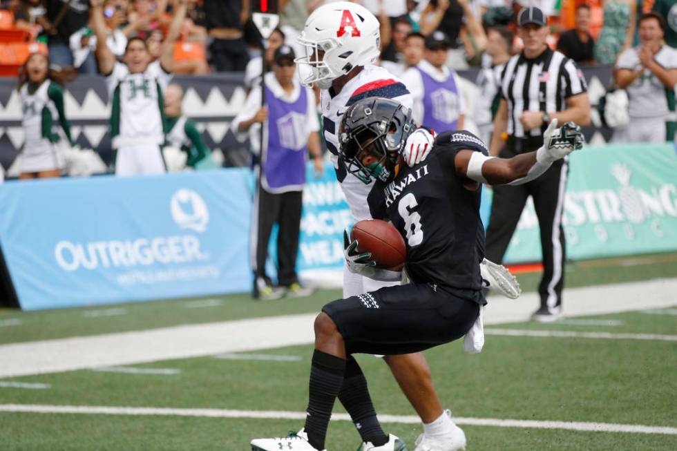 Arizona safety Scottie Young Jr. (6) can't stop Hawaii wide receiver Cedric Byrd II (6) from ma ...