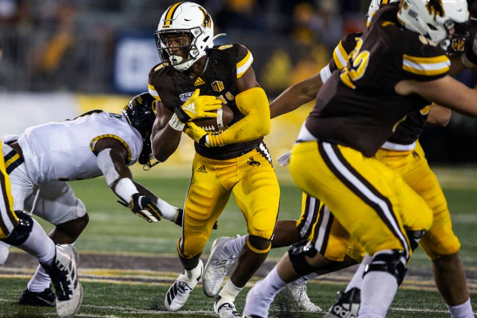 Wyoming's Xazavian Valladay runs for yardage during the fourth quarter against Missouri during ...