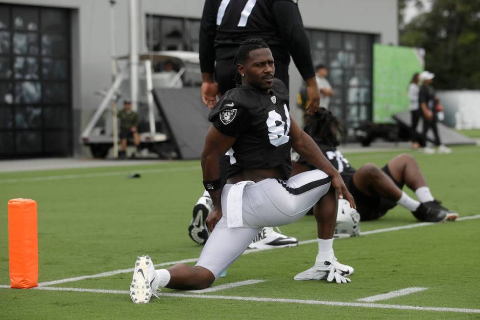 Oakland Raiders' Antonio Brown stretches during NFL football practice in Alameda, Calif., Tuesd ...