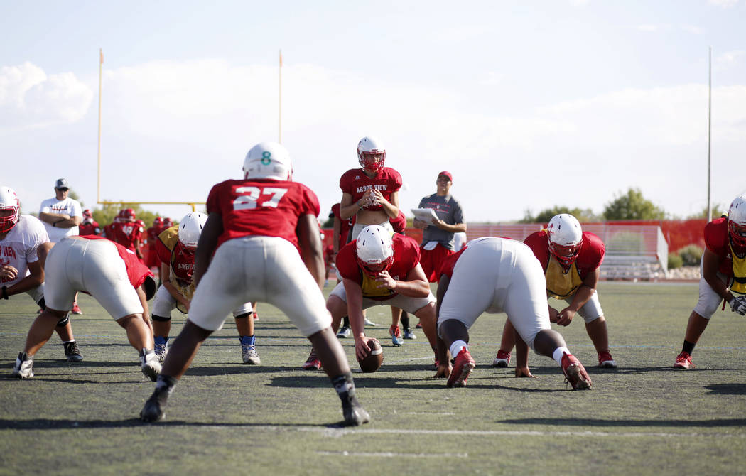 Arbor View's varsity football team runs drills during practice at Arbor View High School in Las ...