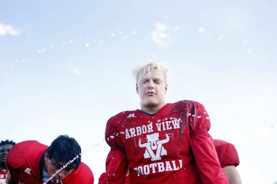 Arbor View's running back Justin Hausner (31), cools off during practice at Arbor View High Sch ...