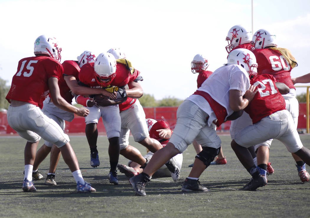 Arbor View's varsity defensive back D'Andre Washington (13), clutches the ball during practice ...
