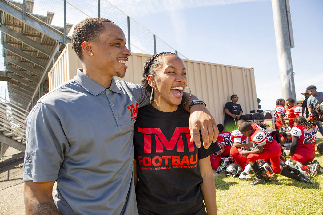 Devin Conway laughs with his wife Alvina Coway during halftime of the youth football TMT Red Li ...