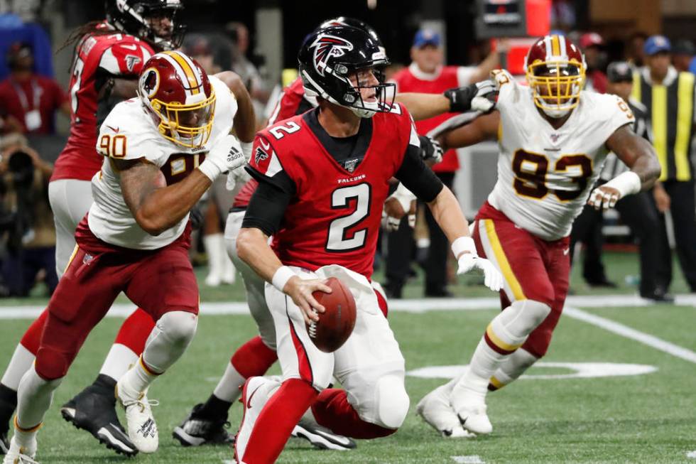 Atlanta Falcons quarterback Matt Ryan (2) runs out of the pocket against the Washington Redskin ...