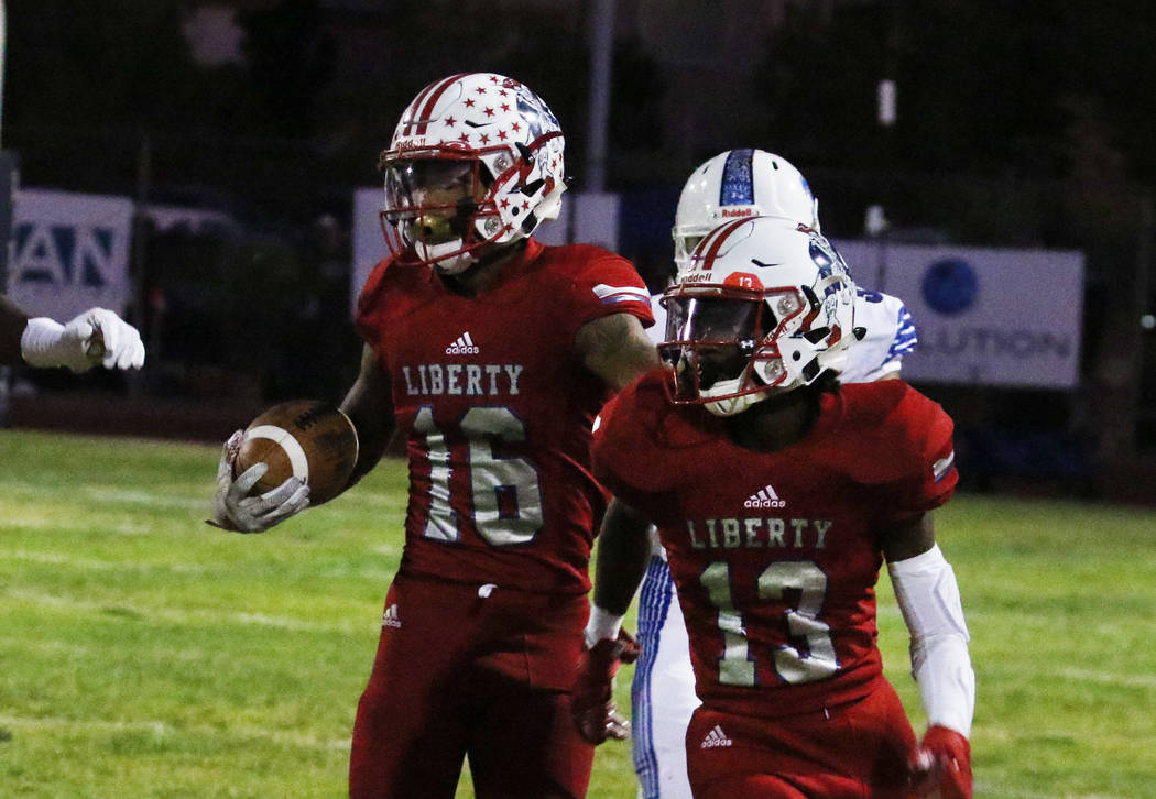 Liberty High's Maurice Hampton (16) runs with the ball during the first half of their game agai ...