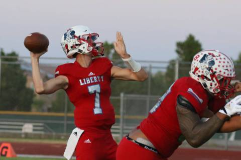 Liberty High's quarterback Kanyon Stoneking throws the ball during the first half of a football ...