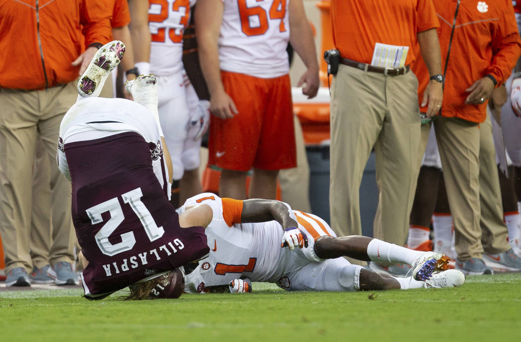 Texas A&M fullback Cullen Gillaspia (12) is flipped over by Clemson cornerback Trayvon Mull ...