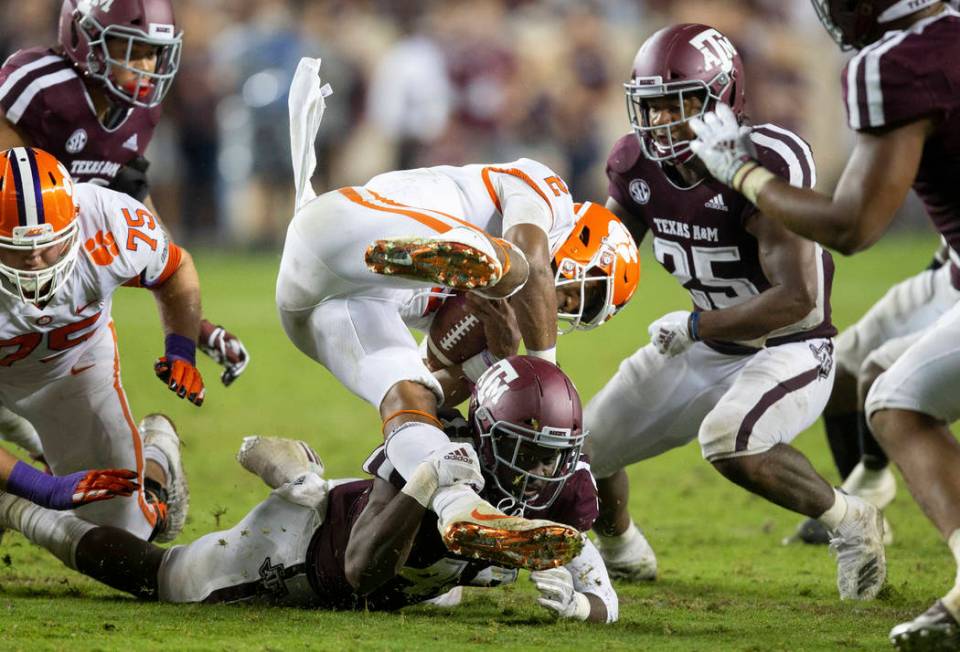 Texas A&M linebacker Otaro Alaka (42) upends Clemson quarterback Kelly Bryant (2) after a s ...