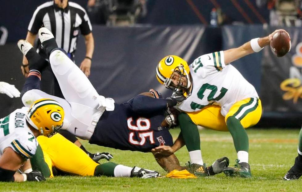 Chicago Bears' Roy Robertson-Harris sacks Green Bay Packers' Aaron Rodgers during the first hal ...