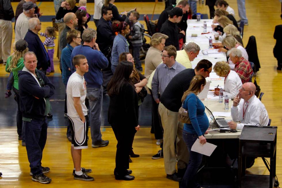 Voters wait to be check in at the voter verification station during the Republican caucus at Ce ...