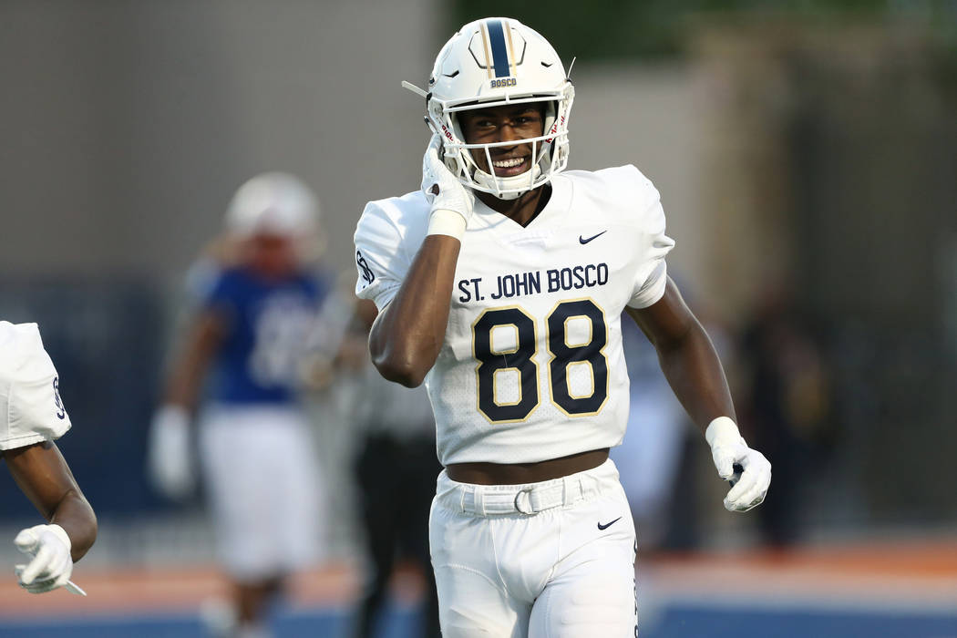 St. John Bosco's Beaux Collins (88) smiles after scoring the first touchdown of the game during ...