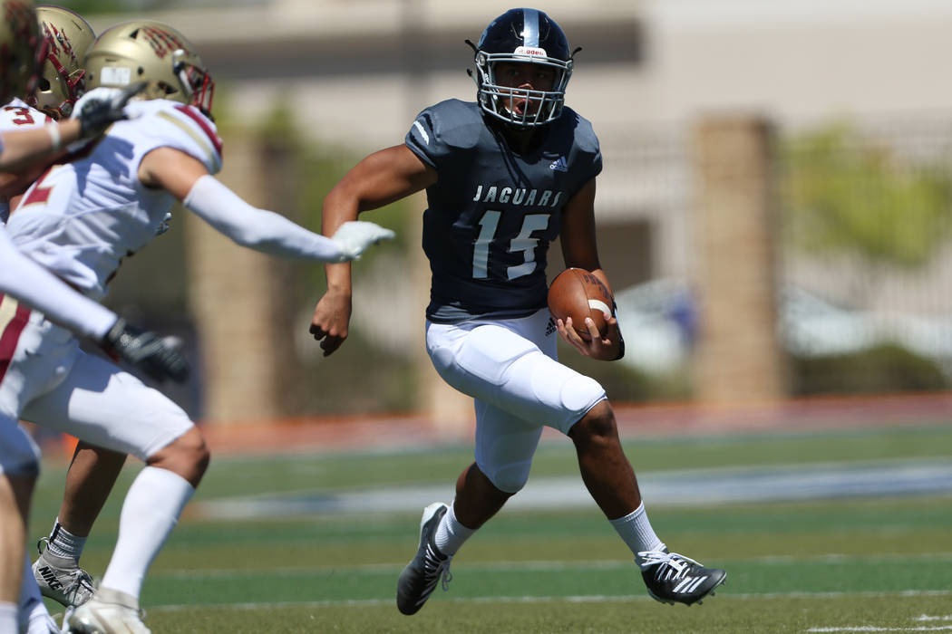 Desert Pines' Rjay Tagatases (15) runs the ball against Logan during the first quarter of the P ...