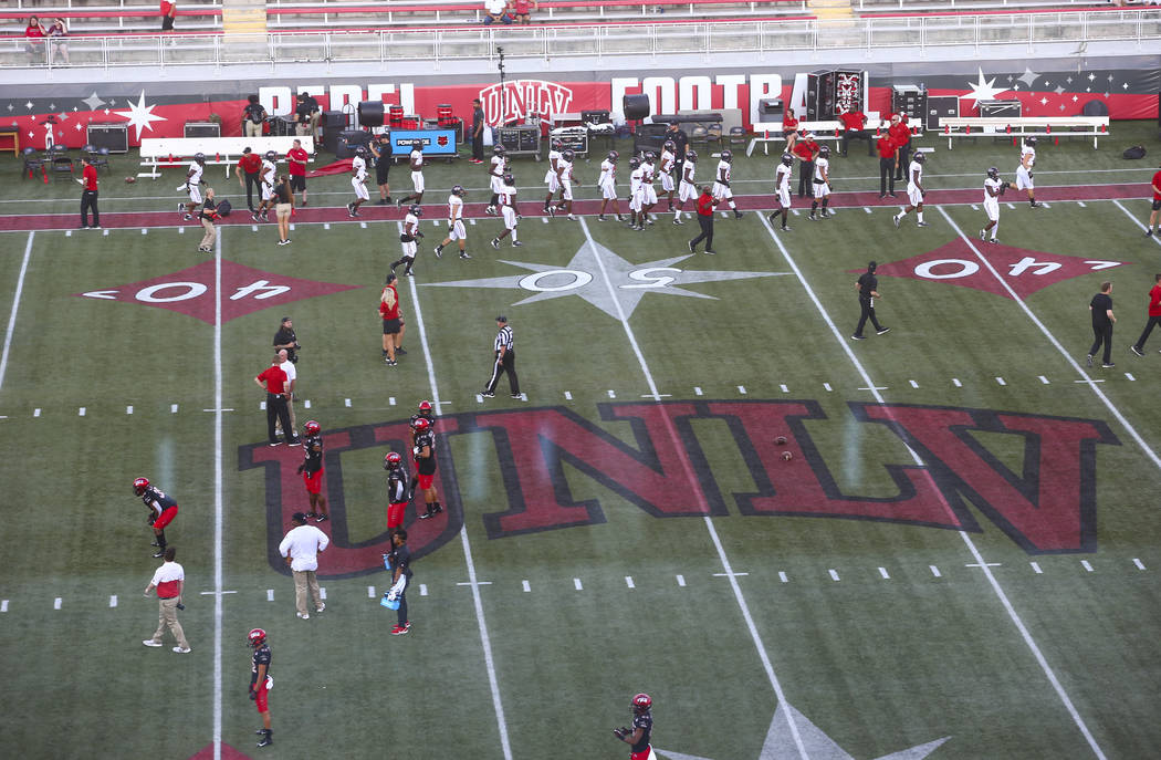 UNLV football players warm up before taking on Arkansas State in an NCAA football game at Sam B ...