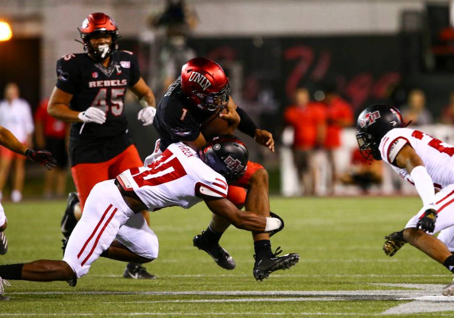 Arkansas State Red Wolves defensive back Detravion Green (20) tackles UNLV Rebels quarterback A ...