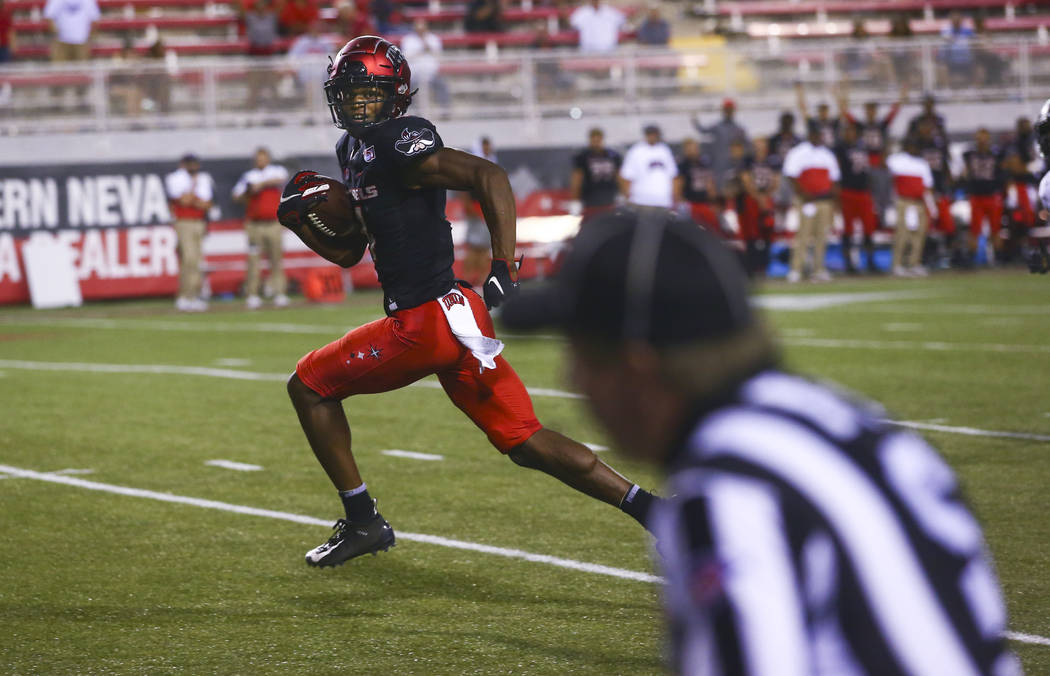 UNLV Rebels wide receiver Randal Grimes runs the ball to score a touchdown against the Arkansas ...