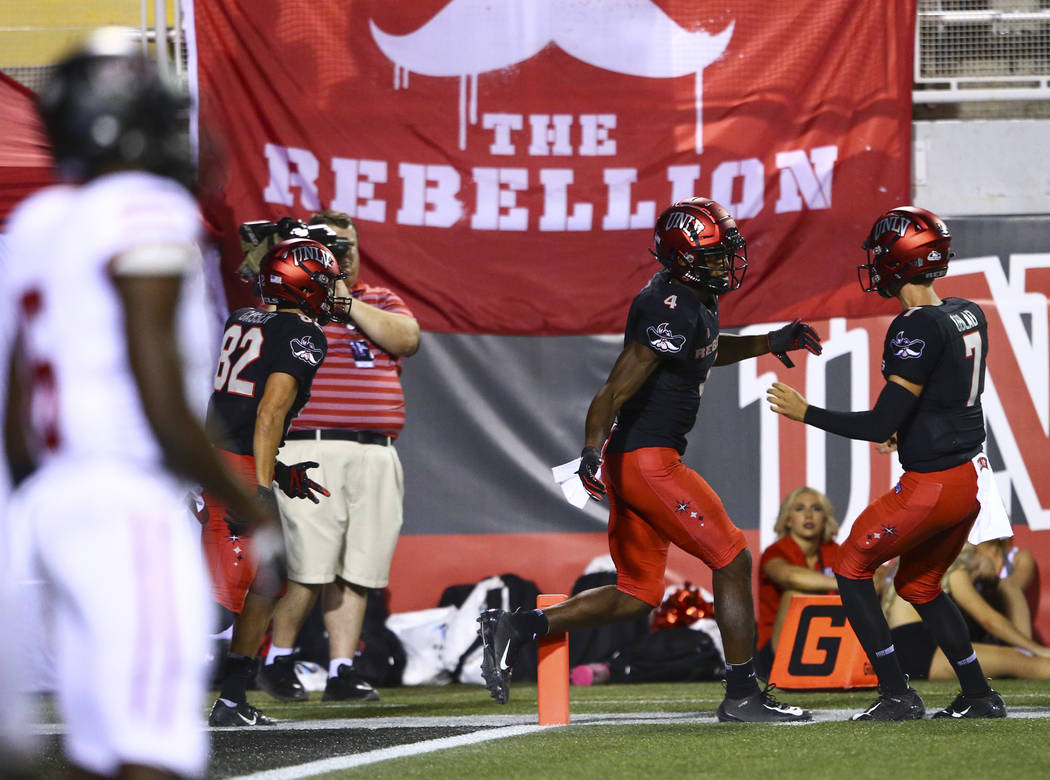 UNLV Rebels wide receiver Randal Grimes (4) celebrates his touchdown with quarterback Kenyon Ob ...