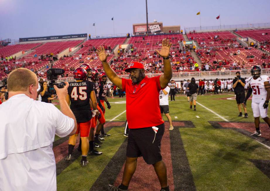 Former UNLV football player Ickey Woods waves at the crowd after participating in the coin toss ...