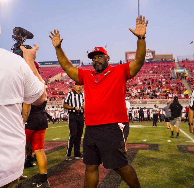 Former UNLV football player Ickey Woods waves at the crowd after participating in the coin toss ...