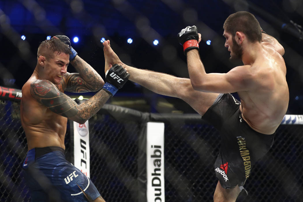 Russian UFC fighter Khabib Nurmagomedov, right, kicks UFC fighter Dustin Poirier, of Lafayette, ...