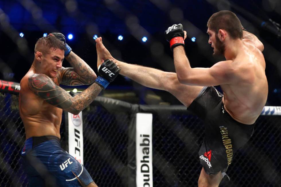 Russian UFC fighter Khabib Nurmagomedov, right, kicks UFC fighter Dustin Poirier, of Lafayette, ...