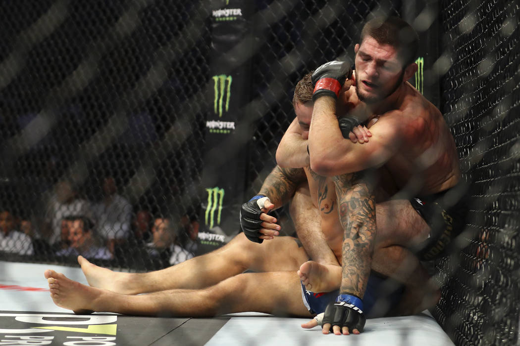 Russian UFC fighter Khabib Nurmagomedov, choke holds UFC fighter Dustin Poirier, of Lafayette, ...