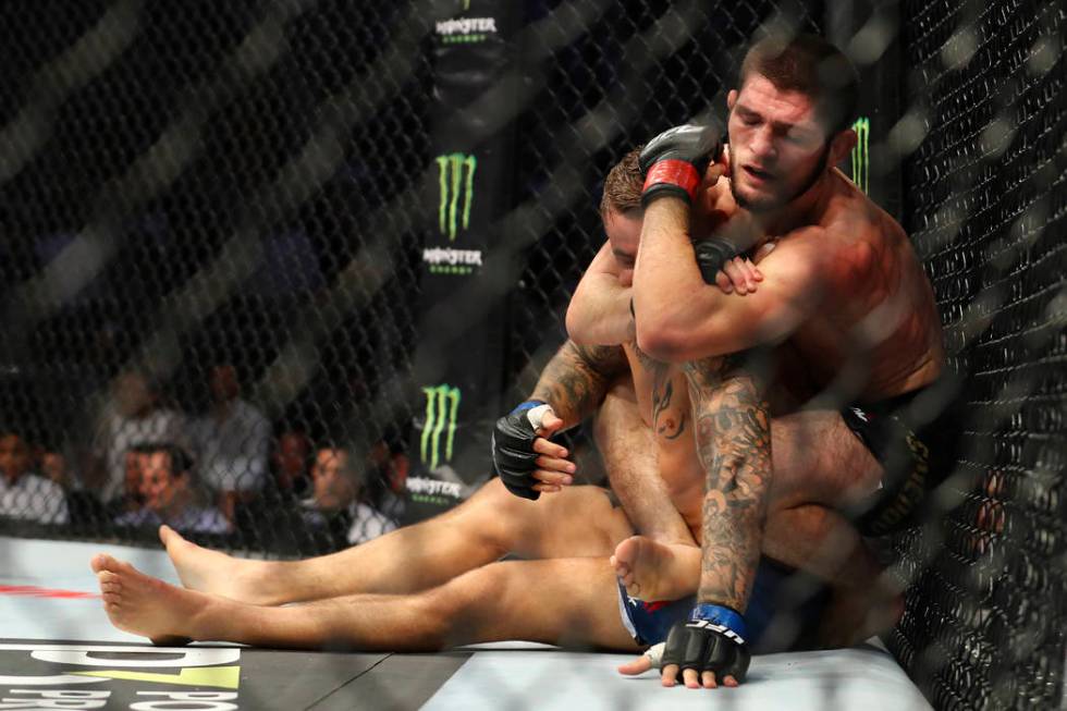 Russian UFC fighter Khabib Nurmagomedov, choke holds UFC fighter Dustin Poirier, of Lafayette, ...