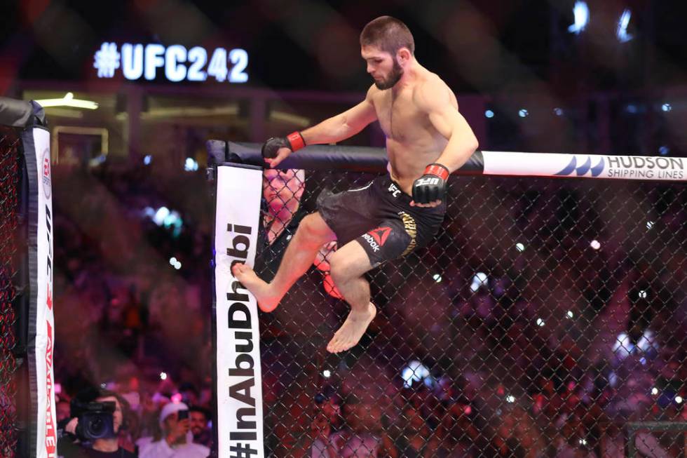 Russian UFC fighter Khabib Nurmagomedov, jumps during Lightweight title mixed martial arts bout ...