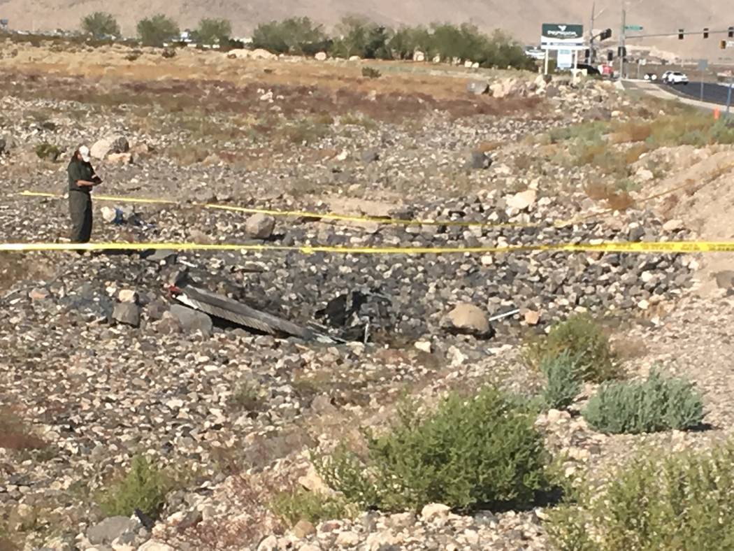 Investigators on scene after a small propeller plane crashed near Henderson Executive Airport o ...