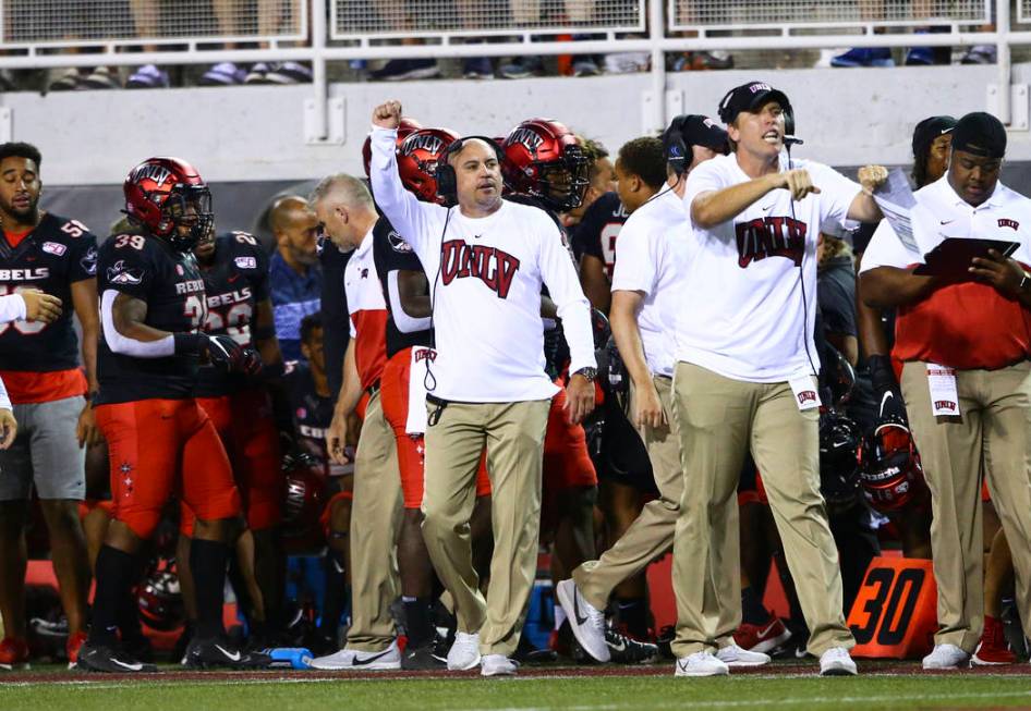 UNLV Rebels head coach Tony Sanchez motions to his team during the second half of an NCAA foot ...