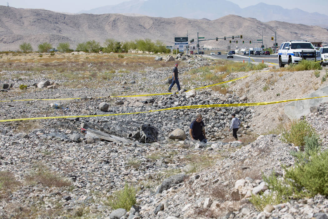 Federal Aviation Administration employees investigate the scene of an airplane crash from Satur ...