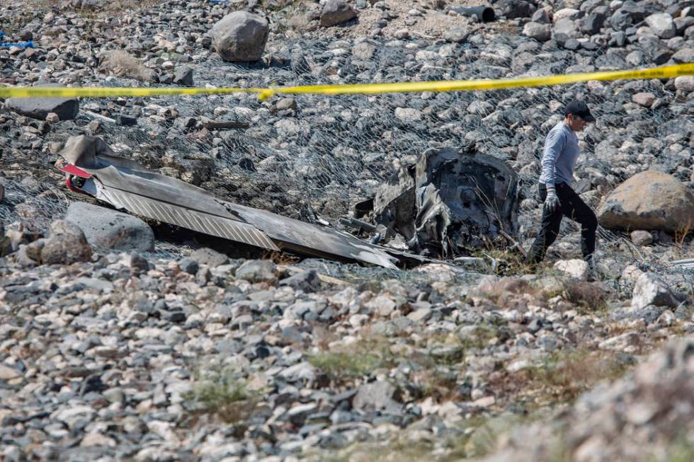 A Federal Aviation Administration employee investigates the scene of an airplane crash from Sat ...