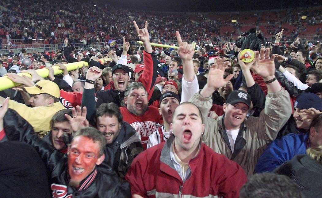 UNLV fans carry a goal post across the field after the Rebel's Las Vegas Bowl victory over Arka ...