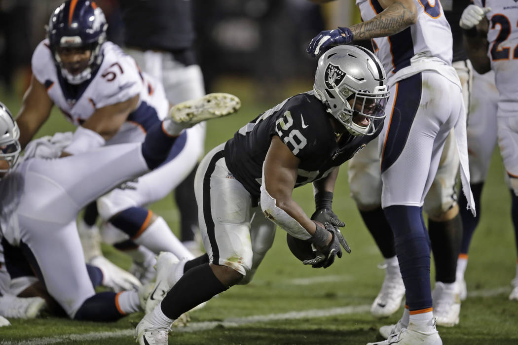 Oakland Raiders running back Josh Jacobs reacts after scoring a touchdown during the fourth qua ...