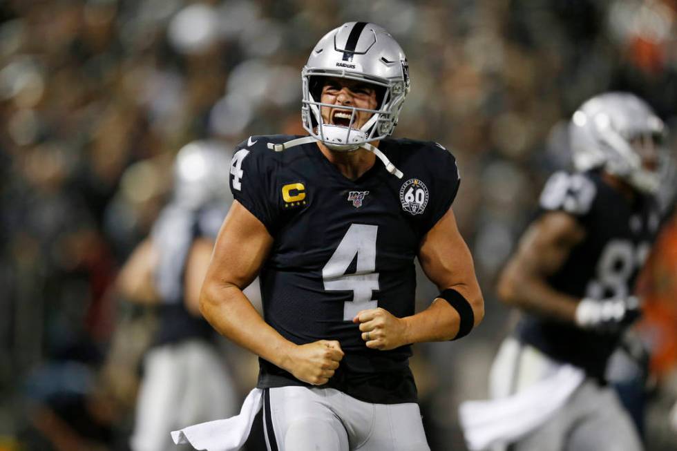 Oakland Raiders quarterback Derek Carr reacts after running back Josh Jacobs scored a touchdown ...