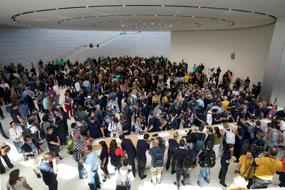 Event attendees get a look at the new products at the Steve Jobs Theater during an event to ann ...