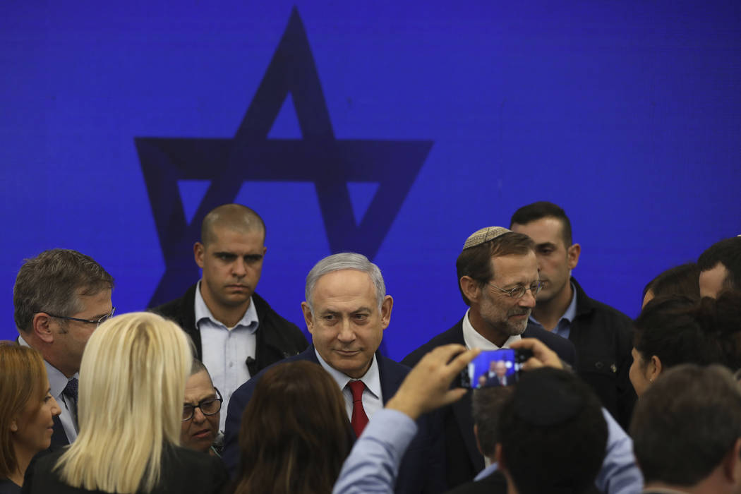 Israeli Prime Minister Benjamin Netanyahu leaves following a press conference in Tel Aviv, Isra ...