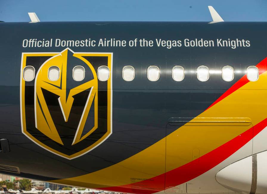 Team markings adorn the plane as Allegiant unveils a new Golden Knights-themed plane at McCarra ...