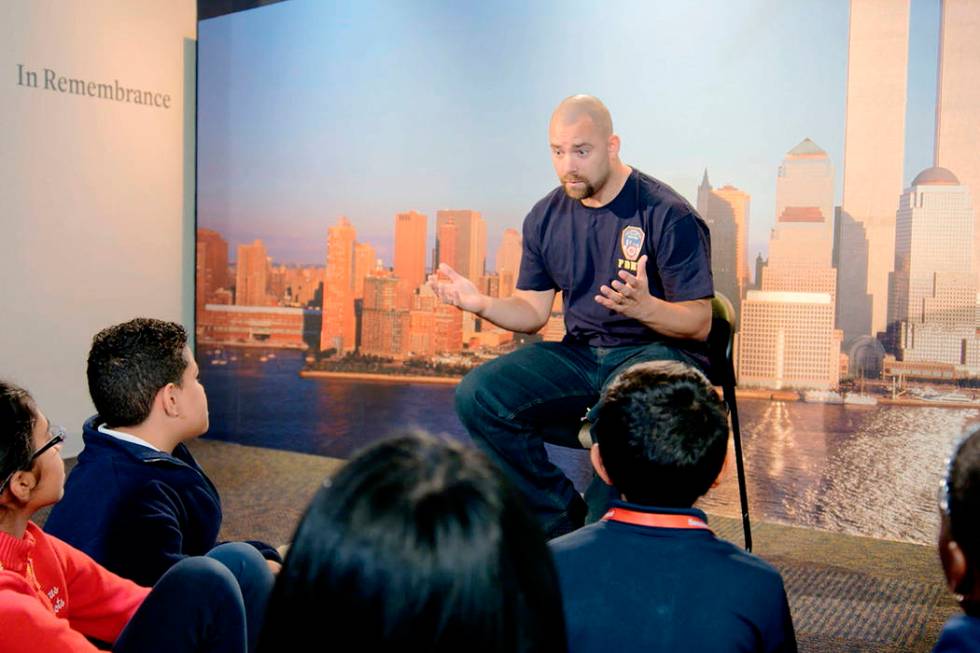 This image released by HBO shows a New York City Fireman speaking to children in a scene from t ...